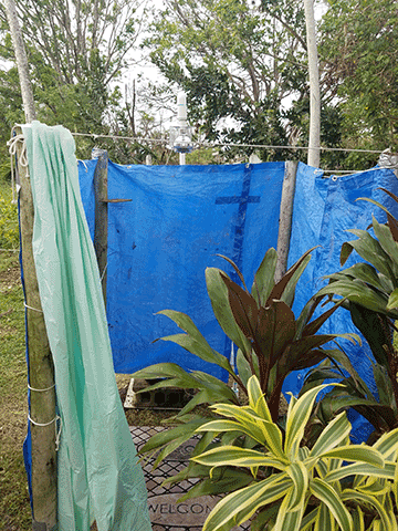 Outdoor shower made of tarps.