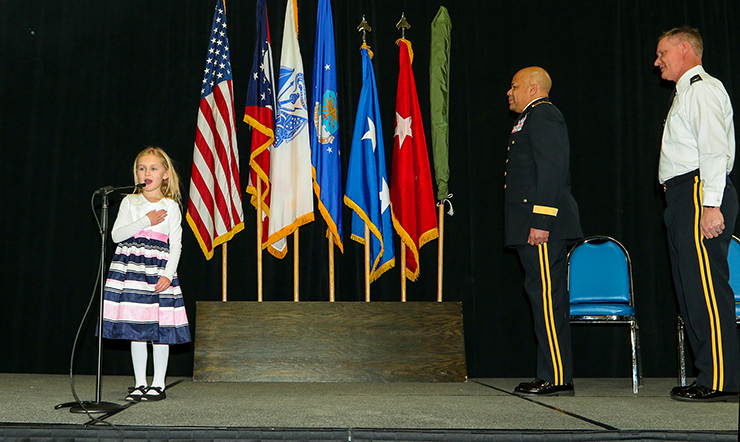 Sarah Stivers leads the Pledge of Allegiance at the beginning of a promotion ceremony for her father, Brig. Gen. Steven E. Stivers.