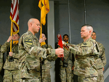 Maj. Eric M. Holtzapple (left), commander of the 204th Engineer Detachment, and Sgt. Maj. Kenneth S. White, 204th Eng. Det. senior enlisted leader, case the unit colors.