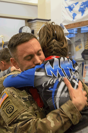 Family members greet their Soldiers after a welcome home ceremony.