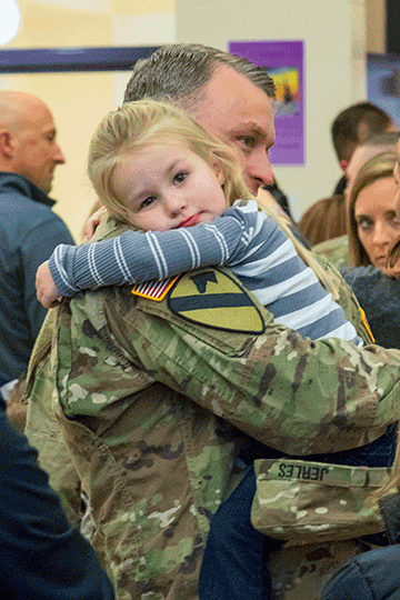 Family members greet their Soldiers after a welcome home ceremony.