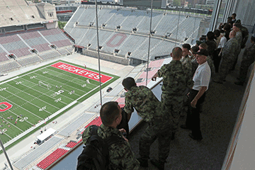 Members of the Serbian and Angolan Armed Forces tour the press box in Ohio Stadium with members of the Ohio National Guard.