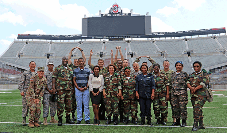 Members of the Serbian and Angolan Armed Forces pose for a group photo with members of the Ohio National Guard in Ohio Stadium .