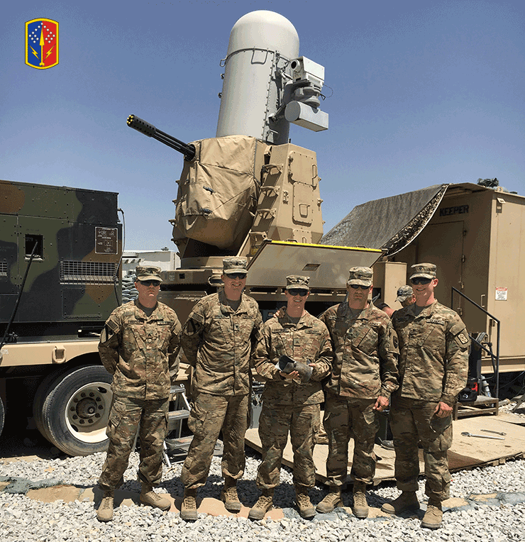 Members of the Ohio Army National Guard’s 2nd Battalion, 174th Air Defense Artillery Regiment, based in McConnelsville, Ohio, stand in front of a Counter-Rocket, Artillery, Mortar (C-RAM) weapon system.