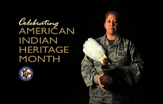 Master Sgt. Serena Dedes  holds a traditional feather flag used during pow wows along with water vase handmade by her mother.