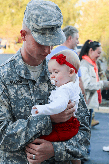 Spc. Christopher Geldine holds his daughter Emma Rose for the first time.