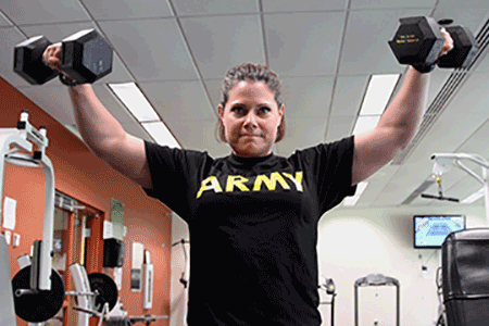 Sgt. 1st Class Megan Simpson works out lifting weights at the gym.