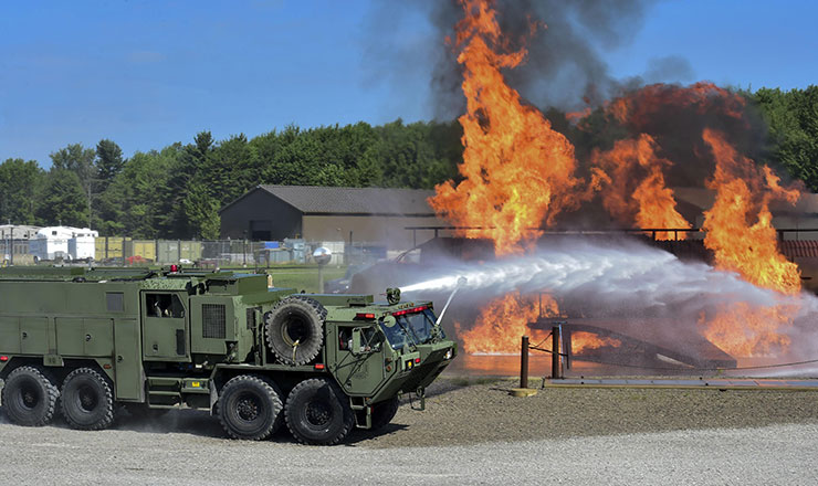 An Army M1142 Tactical Fire Fighting Truck (TFFT) from the Ohio Army National Guard’s 5694th Engineer Detachment arrives at the Youngstown Air Reserve Station burn pit to fight back a blaze.