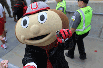 Brutus Buckeye, the mascot of The Ohio State University, greets members of the Ohio National Guard before the kickoff.