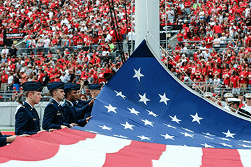 Members of The Ohio State University Reserve Officers’ Training Corps raise the U.S. flag before kickoff.