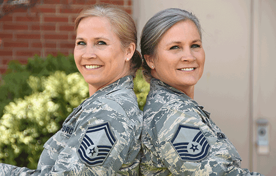 Airguard twin sisters sit back to back.