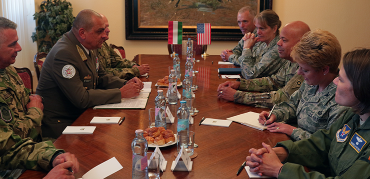 Ohio National Guard leadership sit across from Hungarian Armed Forces leadership at table.