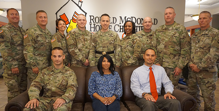 Group photo of members of the Ohio Army National Guard Warrant Officer Candidate School with Kidd's widow in center.