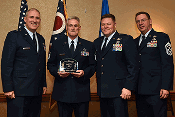 Senior Airman Michael R. White, 2017 Ohio Air National Guard Honor Guard Member of the Year holds award with Maj. Gen. Stephen E. Markovich, Col. James R. Camp and Chief Master Sgt. Thomas A. Jones.