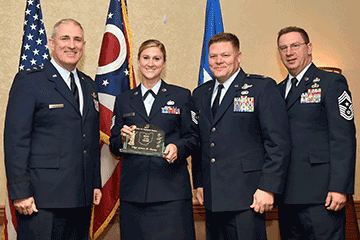 Tech. Sgt. Aimee M. Davey, 2017 Ohio Air National Guard Noncommissioned Officer of the Year holds award while posing with Maj. Gen. Stephen E. Markovich, James R. Camp and Chief Master Sgt. Thomas A. Jones.