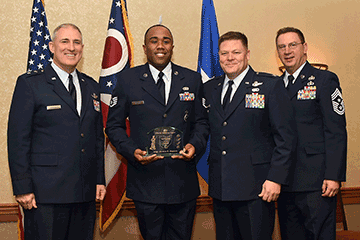 Staff Sgt. Jordan E. Hopson, Ohio Air National Guard Airman of the Year holds award while posing with Maj. Gen. Stephen E. Markovich, Col. James R. Camp and Chief Master Sgt. Thomas A. Jones.