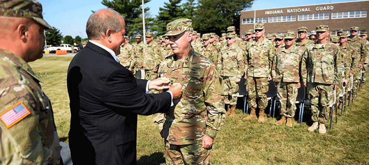 Maj. Gen. Gordon L. Ellis receives his two-star rank from his brother, George, during a promotion ceremony.
