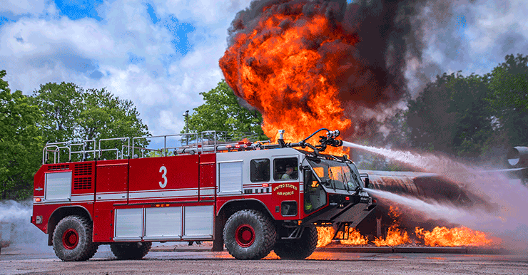 Firetruck sprays aircraft that is onfire.