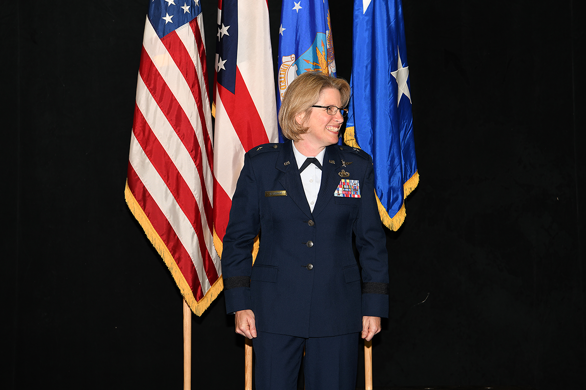 Col. Rebecca L. O’Connor standing on stage