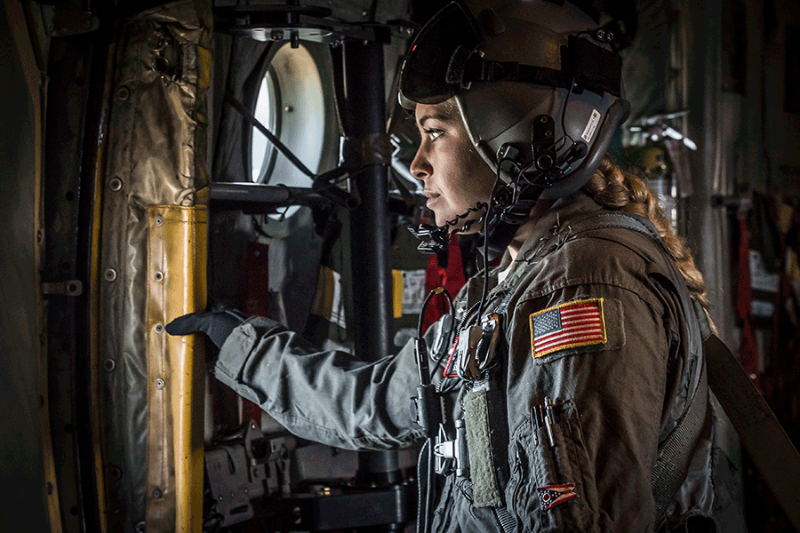 Staff Sgt. Kaitlyn Mueller stands at door inside C-130 Hercules.
