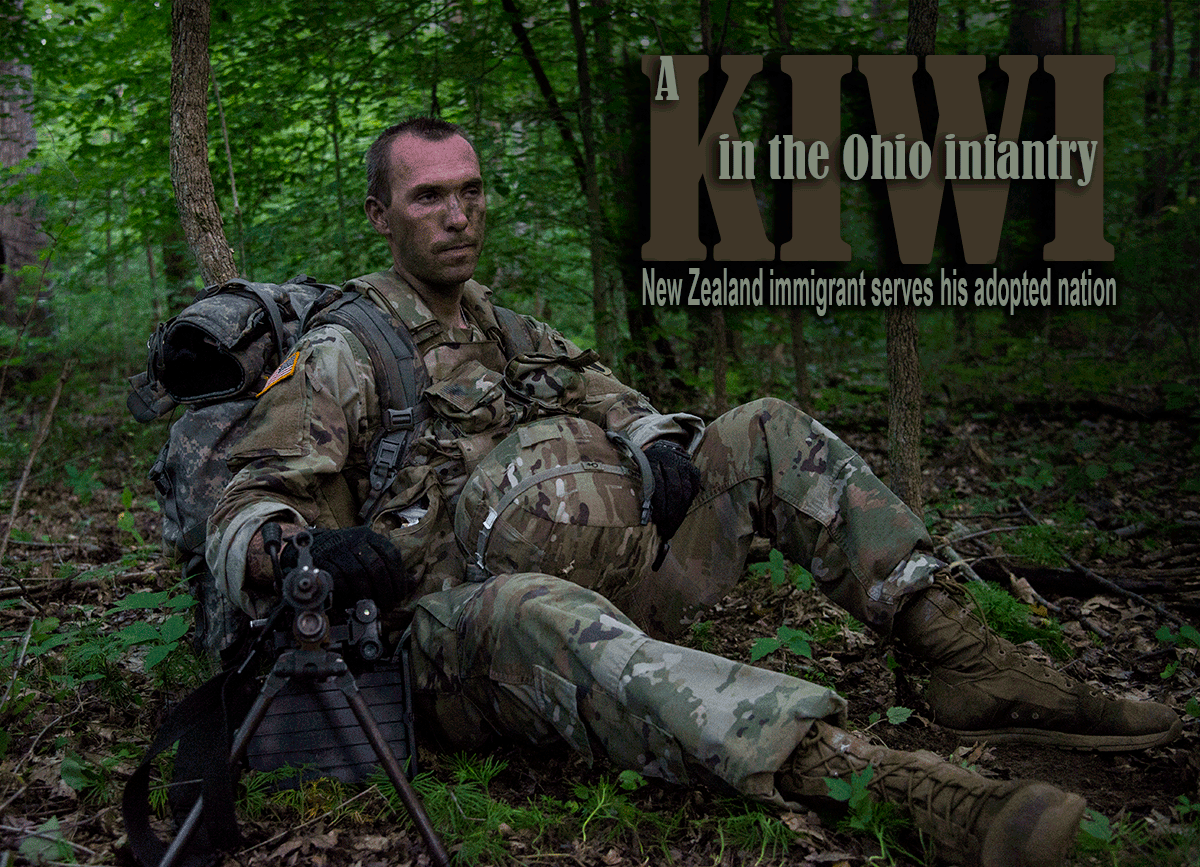 Soldier in camo sitting in woods