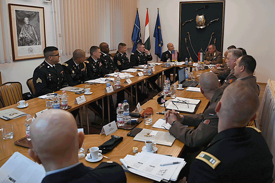 Commanders sitting around large conference table.