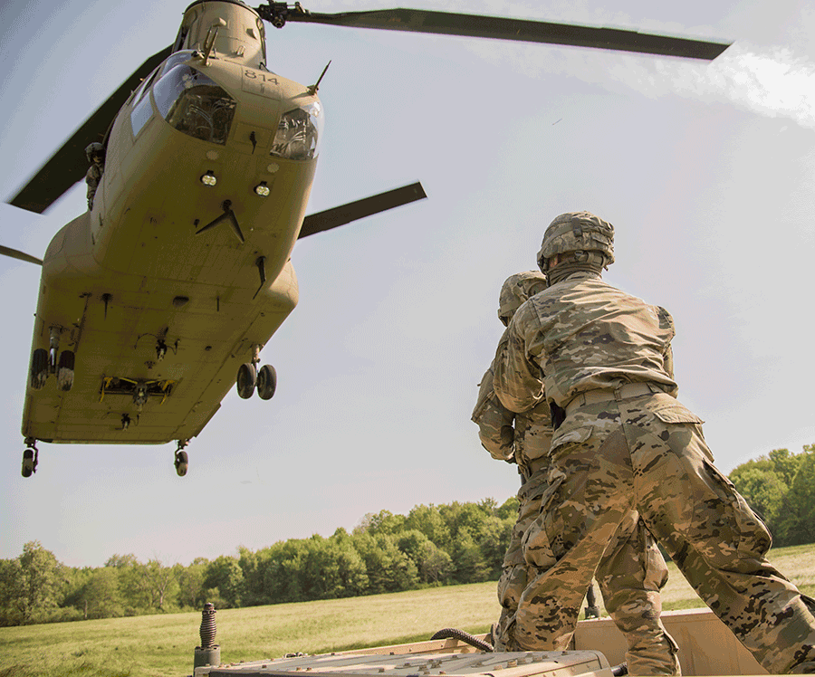 Soldiers wait for a CH-47 Chinook to touch down.