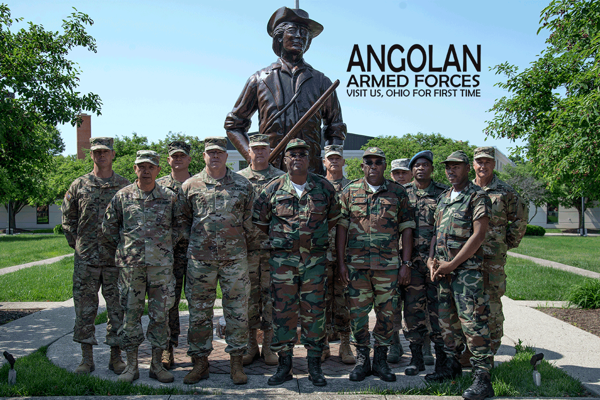 Leadership stand with Angola delegation at minute man statue outside Ohio National Guard Joint Force Headquarters.