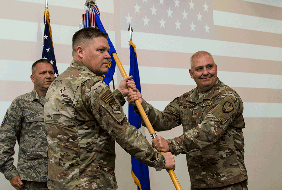 Col. Wade D. Rupper passes the unit guidon to Brig. Gen. James R. Camp.