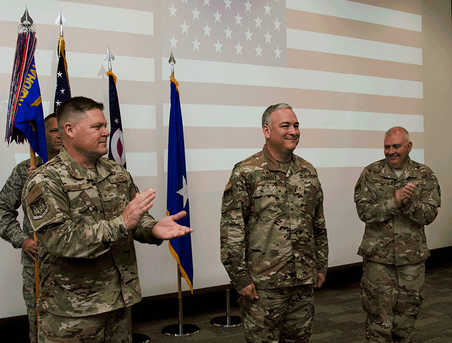 Brig. Gen. James R. Camp and Col. Wade D. Rupper  stand beside Col. Francisco J. Dominguez.