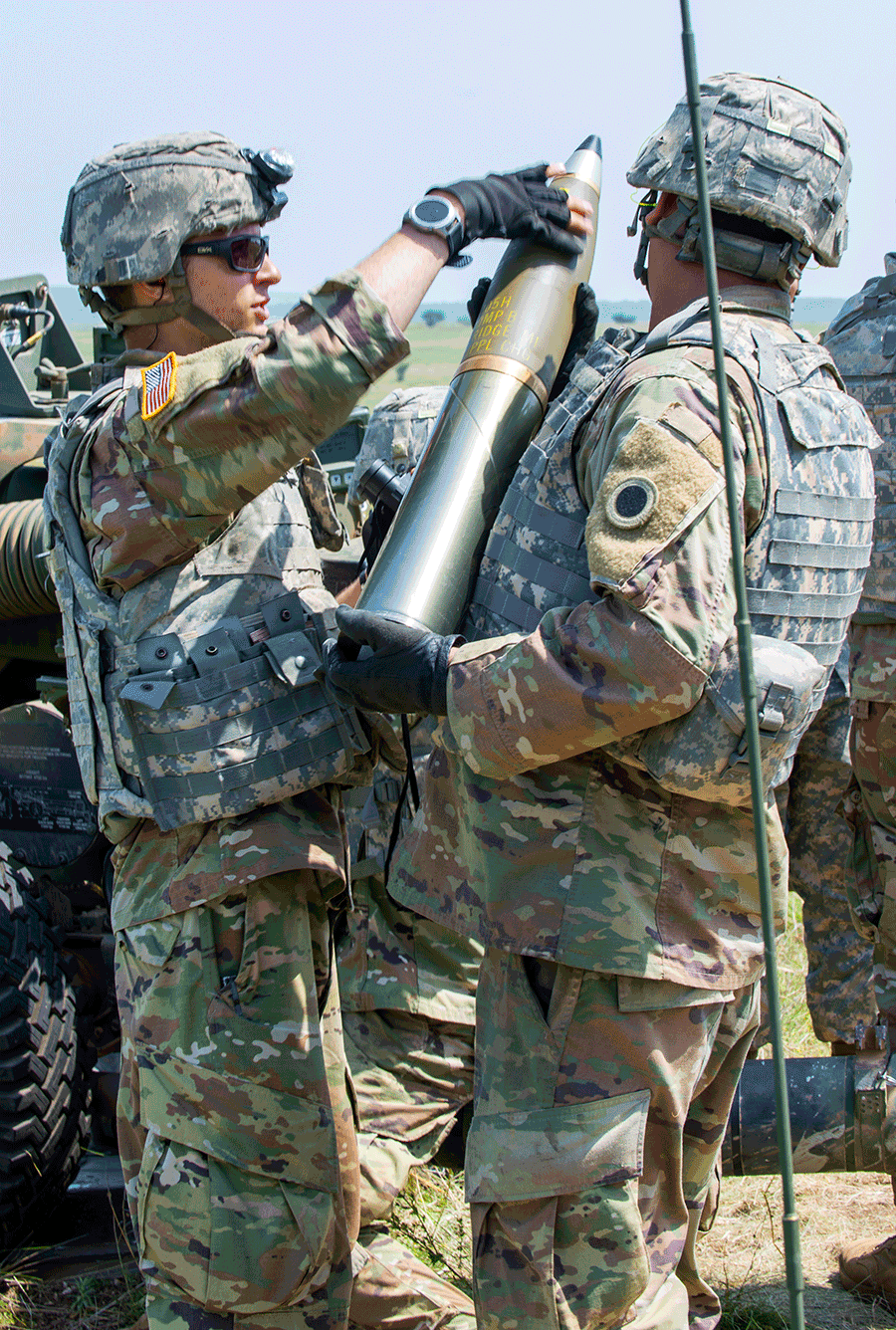 Sgt. Austin Wallace inspects an artillery round prior to firing. 