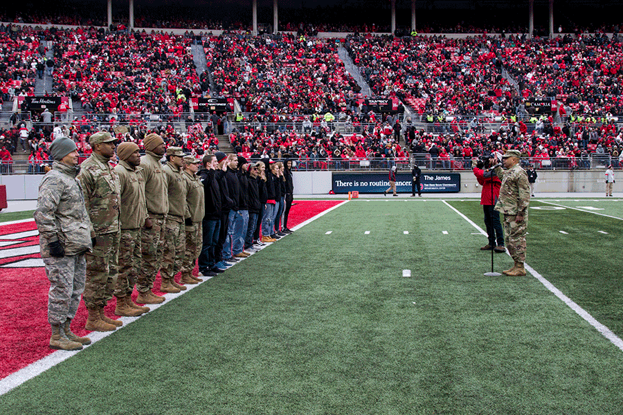 Maj. Gen. John C. Harris Jr., Ohio adjutant general, administers the oath of enlistment to a group of new Soldiers and Airmen on the field.