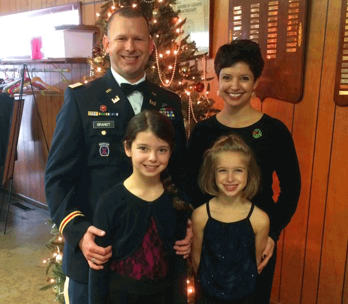 Close up of Brandt with his wife and girls at Holiday party in 2015.