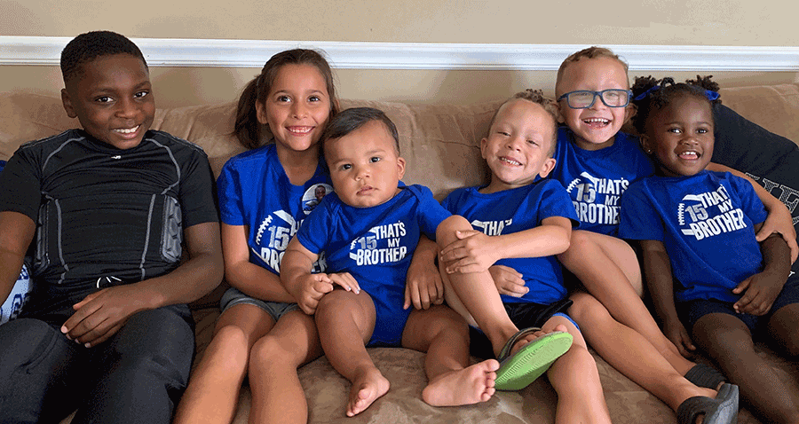 Six children sitting on sofa