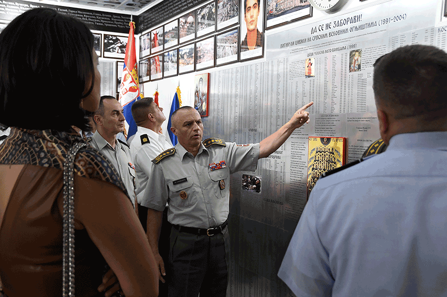 Lt. Gen. Milosav Simović points to names engraved on a memorial wall.