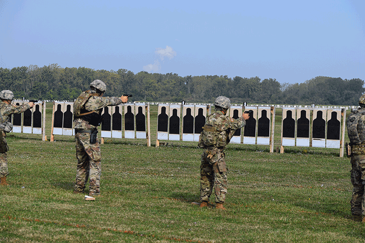 Soldiers shoot at targets outside.