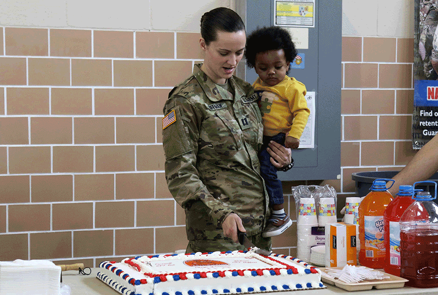 Capt. Jill Hoffman cuts the cake.
