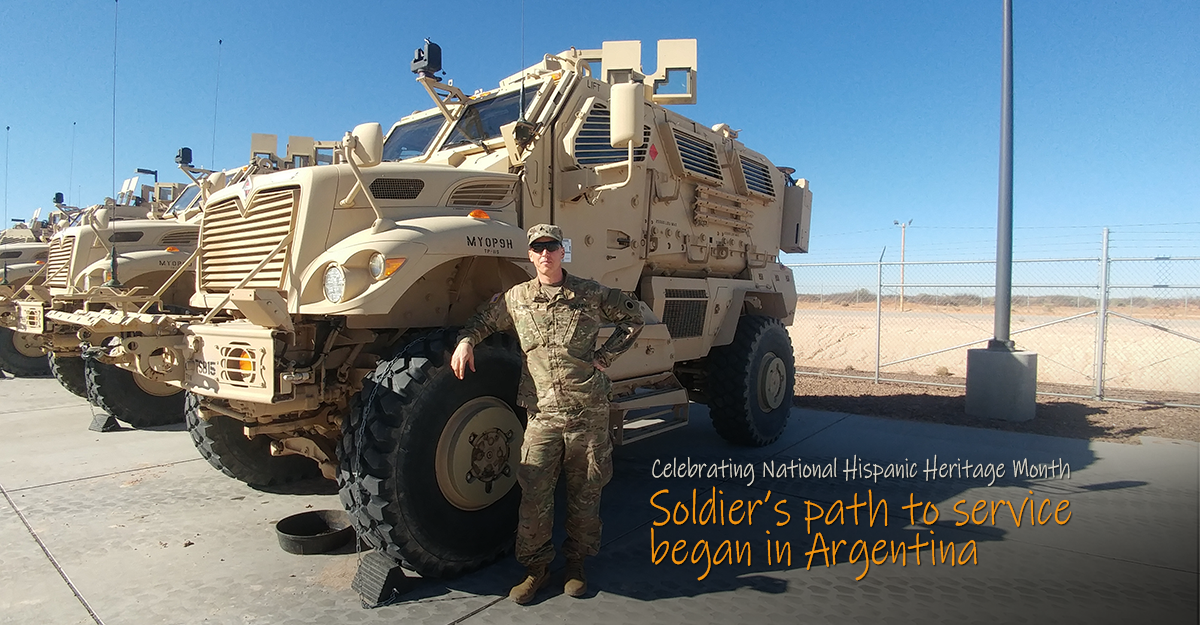 Nemec leans on vehicle in row while on an overseas deployment.