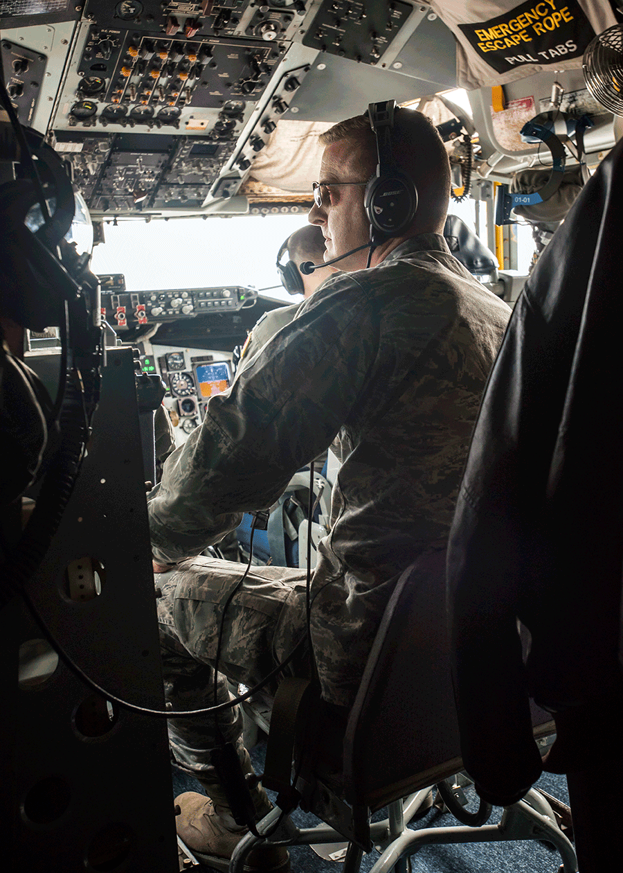 Brig. Gen. Todd M. Audet with flight crew in aircraft.