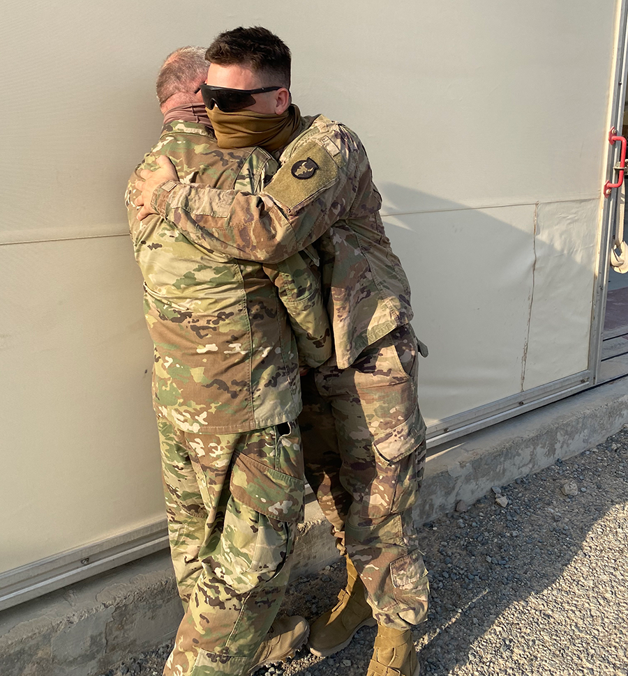 Father and son Solders embrace.