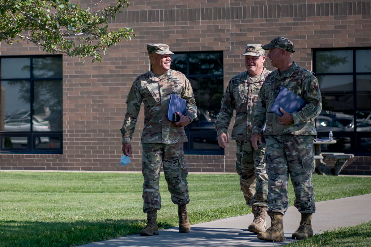 Commanders walking outside of building.