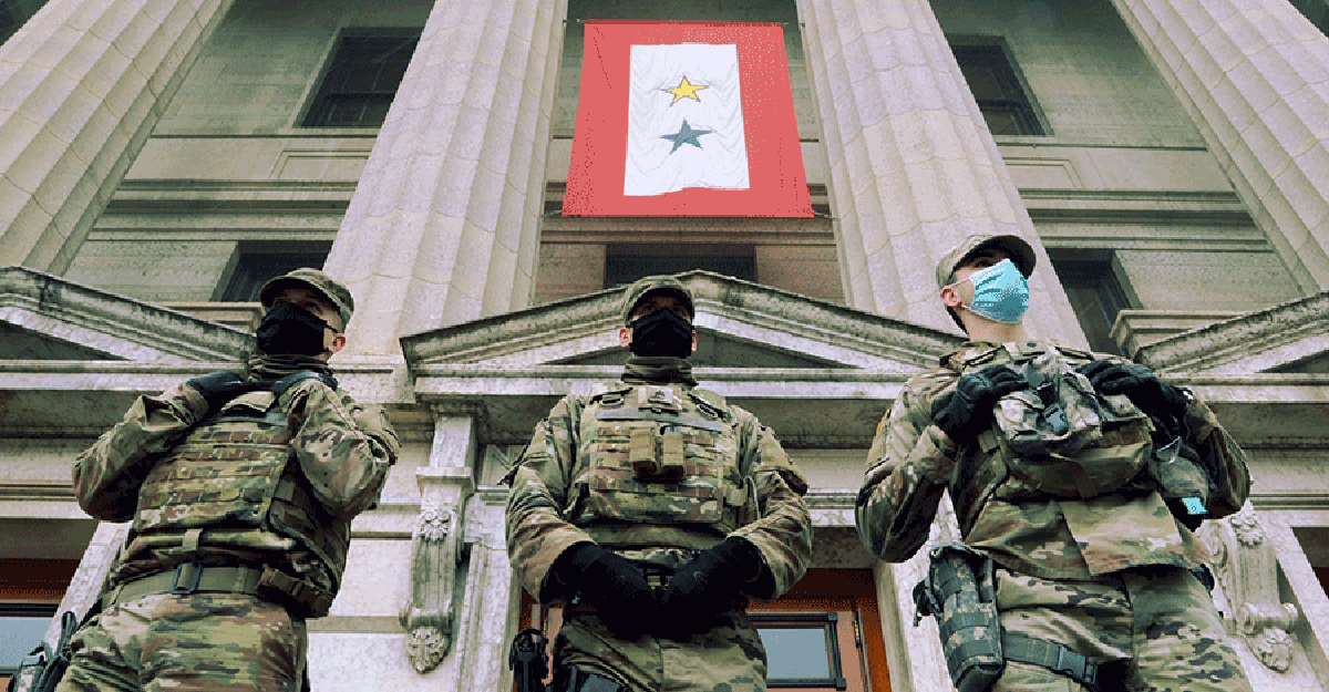 3 Guard Members in front of doors to State Capital.
