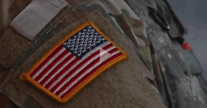 Still from video- American flag patch on Guard's sleeve. 
