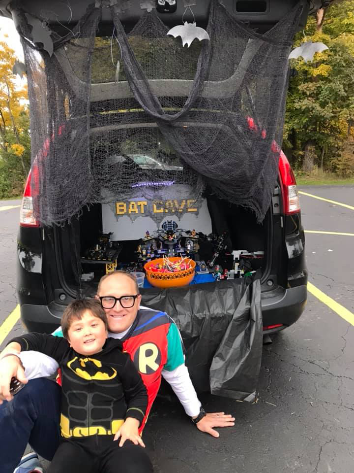 George Davis with son Park dressed in Batman and Robin costumes at trick or trunk event.