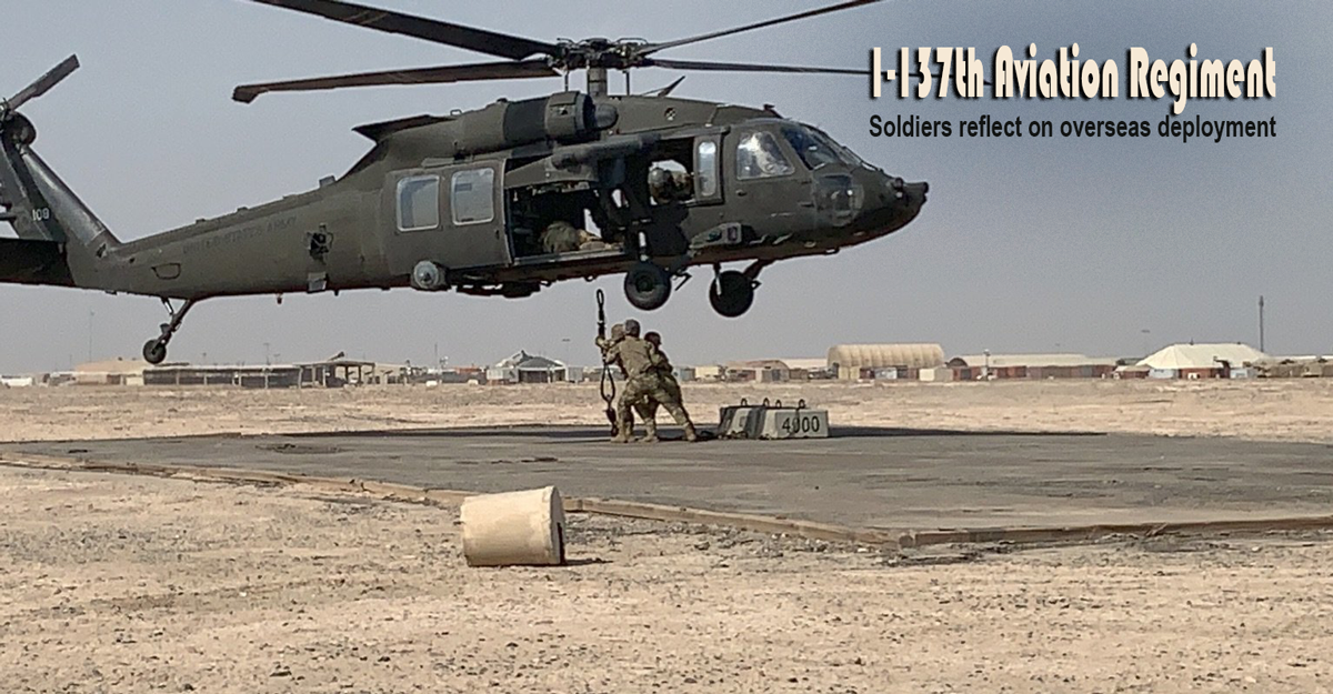Soldiers sling load a simulated piece of military equipment to a UH-60 Black Hawk.