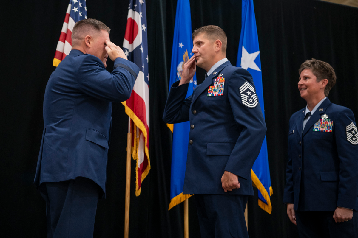 Chief Master Sgt. Troy Taylor salutes Maj. Gen. James R. Camp
