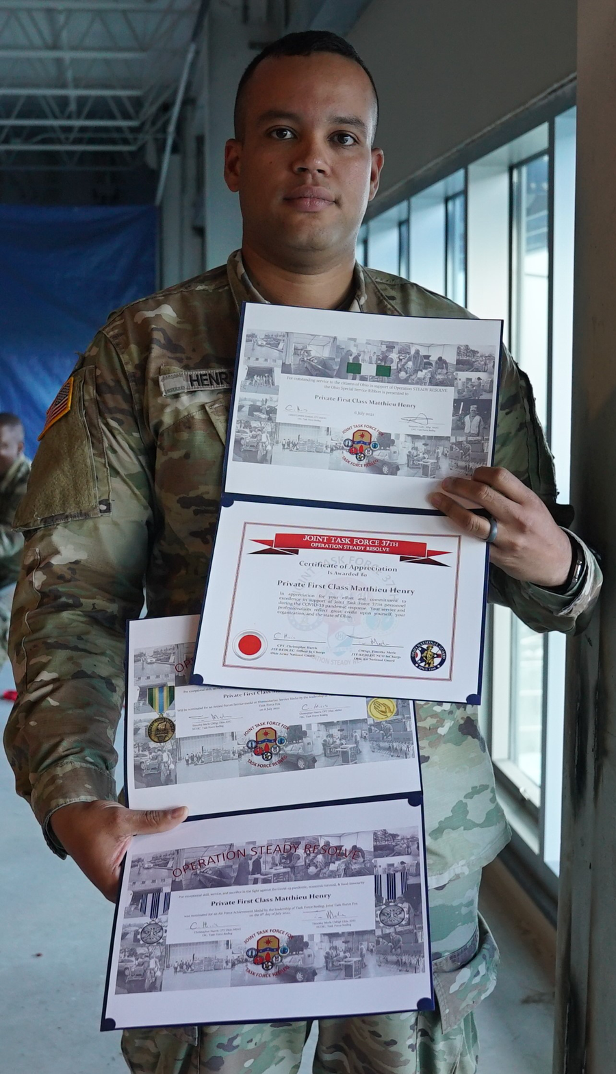 Henry holding certificates
