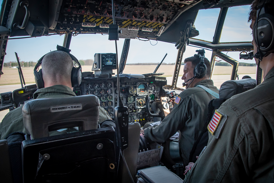 Members inside cockpit of C-130H Hercules.