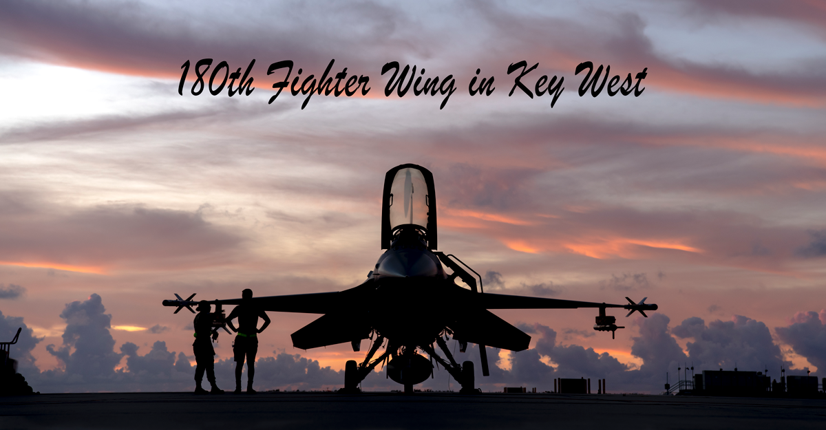 Silhouette of F-16 wuth guard members on tarmak at sunset.