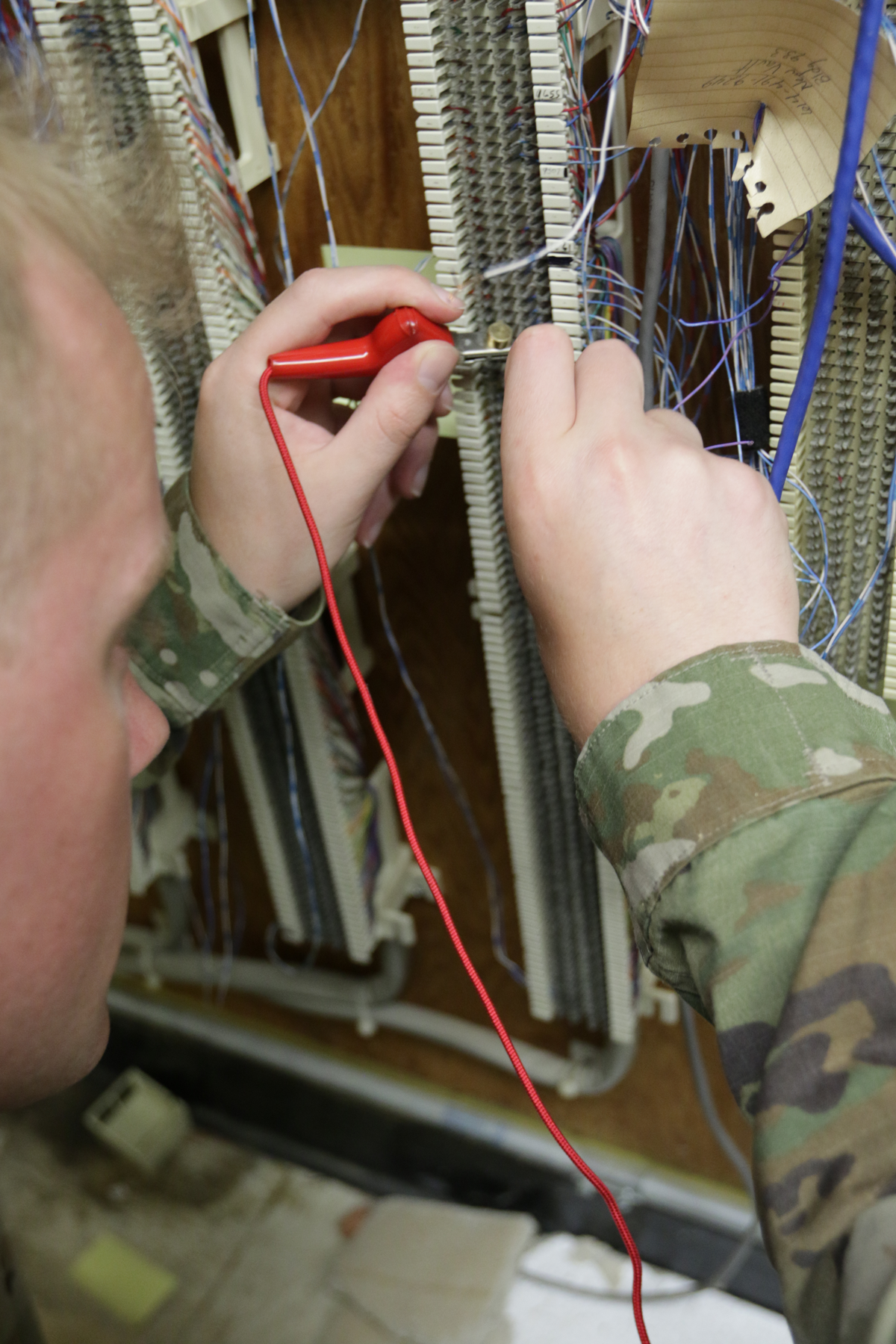 Soldier working on network cables.